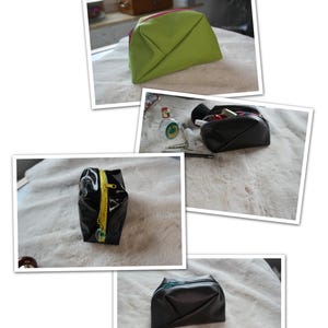 Könnte beinhalten: Eine Sammlung von Kosmetiktaschen in verschiedenen Farben und Stilen. Die Taschen umfassen eine limettengrüne Tasche mit einem rosa Reißverschluss, eine schwarze Tasche mit einem gelben Reißverschluss und eine schwarze Tasche mit einem türkisfarbenen Reißverschluss. Die Taschen liegen auf einer weißen, flauschigen Oberfläche.
