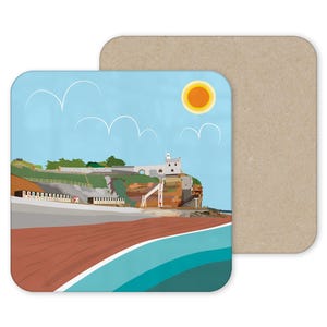 May include: Square coaster depicting a coastal scene with a beach, cliffs, and a building. The design includes a blue sky with clouds and a yellow sun. The coaster is paired with a plain, light brown coaster.