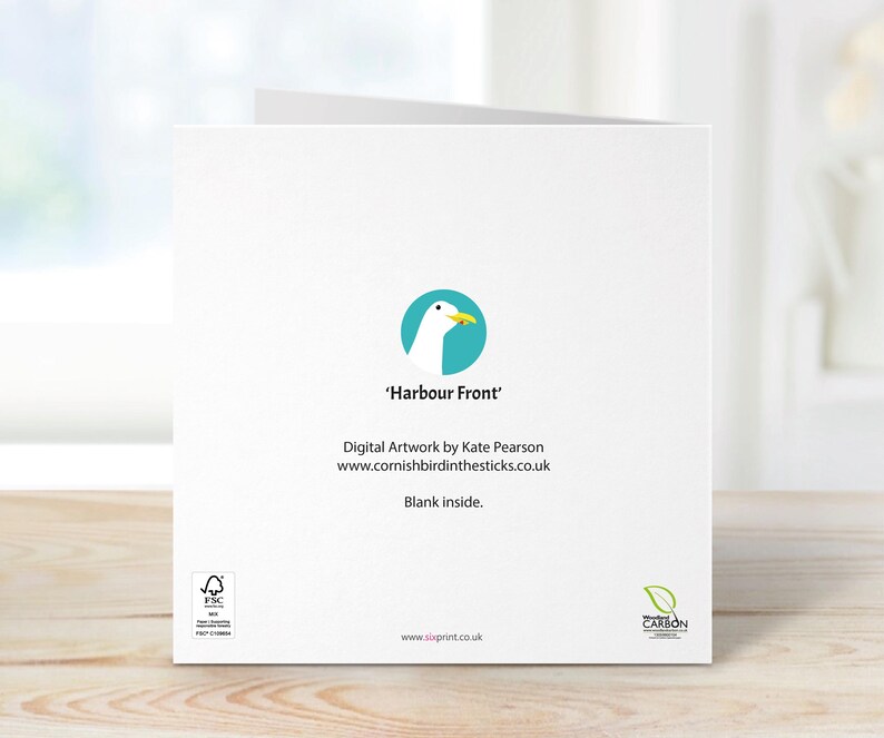May include: A white greeting card with the text "Harbour Front" and a teal circle logo featuring a seagull. The card includes the artist's name and website. The inside of the card is blank.