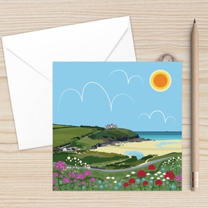 May include: A colourful illustration of a beach scene with a white building on a cliff overlooking a sandy beach with blue water. The sky is blue with white clouds and a bright yellow sun. There are pink, purple and white flowers in the foreground.