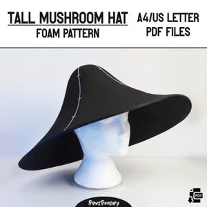 May include: A black foam hat pattern for a tall mushroom hat. The pattern is for A4/US Letter size PDF files. The image shows the hat on a white mannequin head.