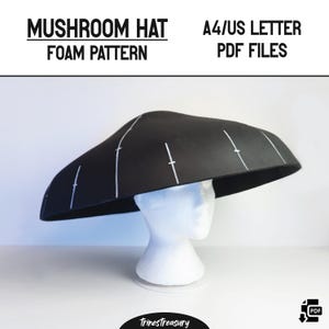 May include: A black mushroom hat foam pattern with white markings, displayed on a white mannequin head. The text "MUSHROOM HAT FOAM PATTERN" and "A4/US LETTER PDF FILES" are visible. This hat is a unique costume accessory.