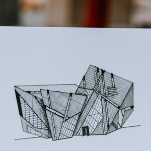 May include: Black and white line drawing of a modern building with a geometric design. The building has a series of angled walls and windows, creating a complex and interesting facade.