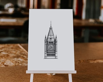 May include: A black and white line drawing of a clock tower on a white card mounted on a small wooden easel.