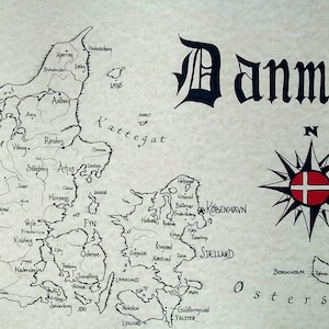 May include: A black and white hand-drawn map of Denmark with the word "Danmark" written in a large, decorative font at the top. The map shows the major cities and islands of Denmark, including Copenhagen, Funen, and Zealand. A compass rose with the Danish flag in the center is located in the lower right corner of the map.