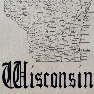 May include: A vintage map of Wisconsin from 1848, showing the state's counties and major cities. The map is drawn in black ink on a beige background. The map is surrounded by a decorative border.