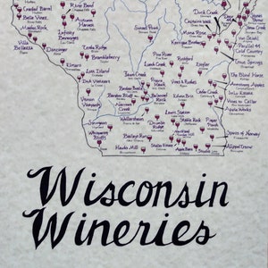 May include: A map of Wisconsin wineries with a compass rose in the top right corner. The map is decorated with purple wine glasses and blue rivers. The text "Wisconsin Wineries" is written in large black cursive letters at the bottom of the map.