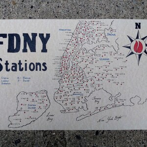 May include: A hand-drawn map of New York City showing the locations of FDNY fire stations. The map is labeled with the boroughs of Manhattan, Bronx, Queens, Staten Island, and Brooklyn. The map also includes a compass rose with a red and black fire emblem.