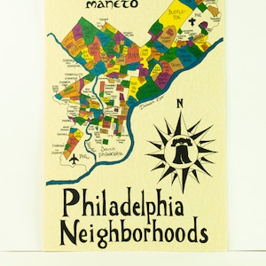 May include: A colorful map of Philadelphia neighborhoods with the Liberty Bell in the center. The map shows the names of different neighborhoods, including Germantown, Manayunk, Fairmount, and South Philadelphia. The map is surrounded by a blue border and a compass rose.