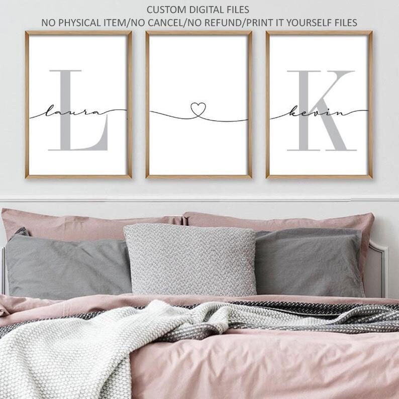 May include: Three framed prints featuring the letters L and K in grey, with the names Laura and Kevin written in cursive underneath. The centre print has a small heart drawn with a line connecting the two sides.