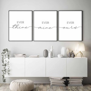 May include: Three black framed prints with white backgrounds and black calligraphy. The prints read "Ever thine", "Ever mine", and "Ever ours".