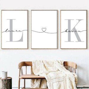 May include: Three framed prints featuring the letters L, a heart, and K, with the names Laura and Kevin written beneath each letter.