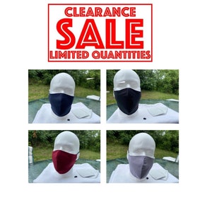 May include: Four face masks on mannequins, each with a different color: black, navy blue, burgundy, and gray.  The masks are all made of fabric and have a filter pocket.  The mannequins are all wearing white shirts.  The image has the text "CLEARANCE SALE LIMITED QUANTITIES".