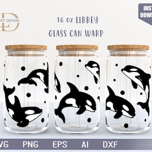 Puede incluir: Tres tarros de vidrio de 473 ml con tapas de madera, cada uno con un diseño de ballena orca en blanco y negro. Los tarros son transparentes y tienen un fondo blanco con puntos negros. El texto "16 oz LIBBEY GLASS CAN WARP" está impreso sobre un fondo blanco encima de los tarros.
