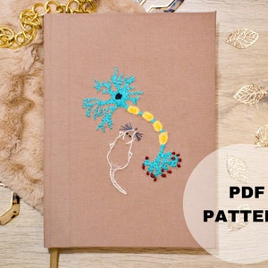 May include: A brown notebook with a blue and yellow embroidered design of a neuron and a mouse. The text "PDF PATTERN" is on a white circle in the lower right corner of the image.