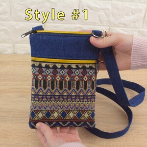 Handmade crossbody bag labeled 'Style #1', featuring a dark blue denim top section, yellow (golden color) zippers, and a bottom pocket made from tapestry textile (geometric pattern).