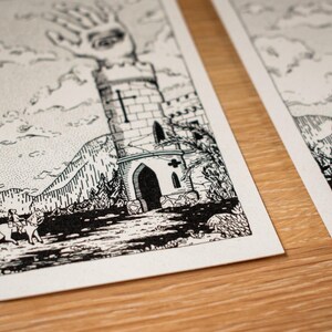 May include: Black and white illustration prints featuring a medieval tower with a hand emerging from the top, a rider on horseback, and mountainous landscapes. The artwork is detailed with cross-hatching and stippling techniques, creating a textured effect.