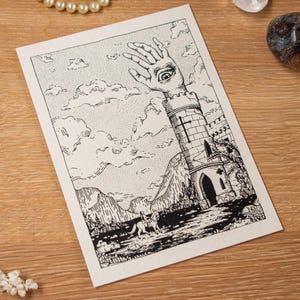May include: Black and white illustration on a cream-colored card. The artwork depicts a hand with an eye in the palm emerging from a tower. A figure on a horse is in the foreground. The background shows mountains and clouds.