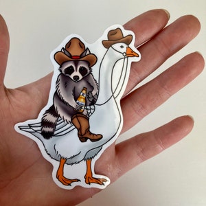 Cowboy Raccoon on a goose with a beer | funny raccoon sticker