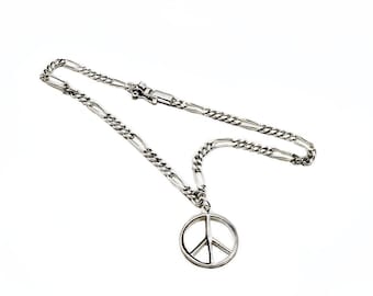 May include: A silver-colored necklace featuring a peace symbol pendant. The pendant is a circular design with a vertical and two diagonal lines. The chain is a linked design with a clasp.