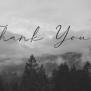 May include: A monochrome image featuring a forest and mountains, with the words "Thank You!" written in cursive. The text is positioned above the trees, set against a backdrop of a cloudy sky.