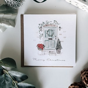 Porta de casa em aquarela de cartão de Natal com guirlanda