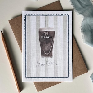 May include: A birthday card featuring a watercolor illustration of a pint of Guinness stout. The card has a striped background and a scalloped border. The words "Happy Birthday" are written below the pint.