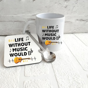 May include: White mug with a black and yellow graphic that says "Life without music would be..." with a guitar and a heartbeat graphic. A white coaster with the same graphic and a silver guitar-shaped spoon.