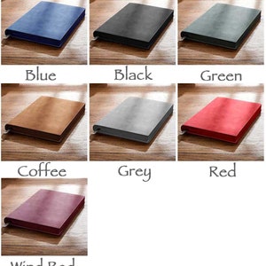 May include: A set of six notebooks in various colors, including blue, black, green, coffee, grey, red, and wind red. The notebooks are all closed and have a soft, textured cover.