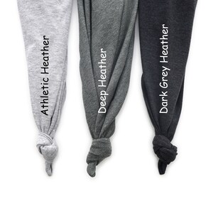 May include: Three fabric swatches in different shades of gray. The swatches are labeled "Athletic Heather", "Deep Heather", and "Dark Grey Heather".