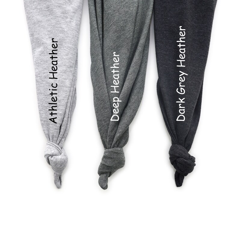 May include: Three fabric swatches in different shades of gray. The swatches are labeled "Athletic Heather", "Deep Heather", and "Dark Grey Heather".