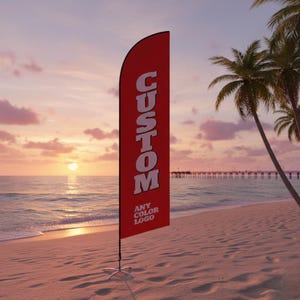 May include: A red custom feather flag with white text that reads "CUSTOM" and "ANY COLOR LOGO". The flag is displayed on a sandy beach with palm trees and a pier in the background. The sky is a gradient of orange and pink.
