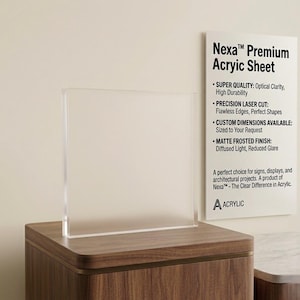 May include: A clear acrylic sheet with a matte frosted finish stands on a wooden surface. The sheet is displayed next to a white sign that reads "Nexa Premium Acrylic Sheet" and lists features like optical clarity and custom dimensions.