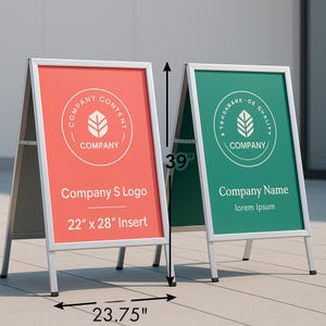 May include: Two silver A-frame signs with red and green inserts. The red sign has a company logo and text, with dimensions of 22" x 28". The green sign features a logo and text. The signs are 39" tall and 23.75" wide.