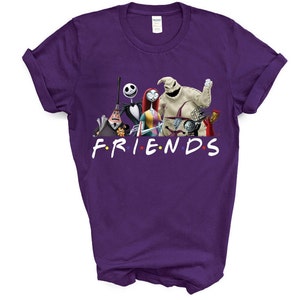 May include: Purple t-shirt featuring a graphic of characters from the Nightmare Before Christmas film. The characters are standing in a line and the text "FRIENDS" is below them.