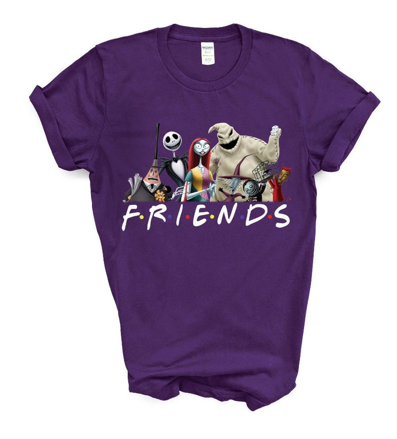 May include: Purple t-shirt featuring a graphic of characters from the Nightmare Before Christmas film. The characters are standing in a line and the text "FRIENDS" is below them.