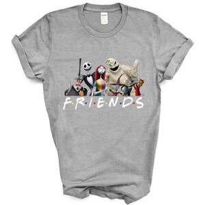 May include: A grey t-shirt featuring a graphic of characters from the film "The Nightmare Before Christmas" and the word "FRIENDS" in colourful letters.
