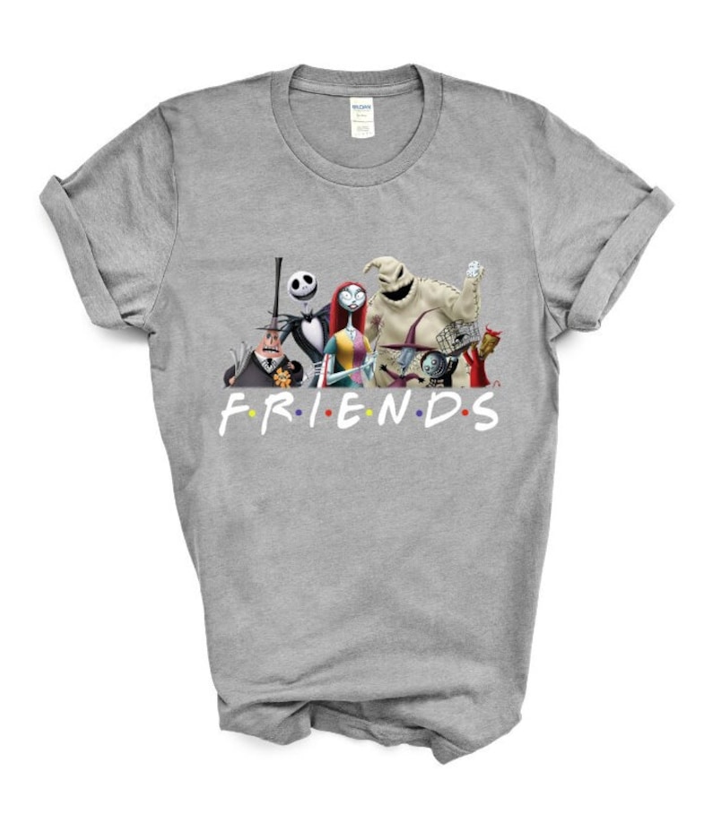 May include: A grey t-shirt featuring a graphic of characters from the film "The Nightmare Before Christmas" and the word "FRIENDS" in colourful letters.