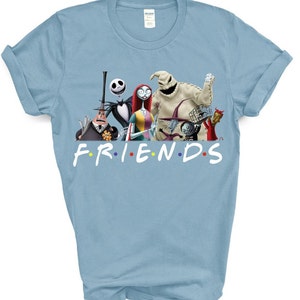 May include: Light blue t-shirt featuring a graphic of the characters from the Nightmare Before Christmas film. The text "FRIENDS" is printed below the characters in a colourful font.