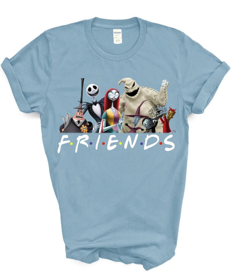 May include: Light blue t-shirt featuring a graphic of the characters from the Nightmare Before Christmas film. The text "FRIENDS" is printed below the characters in a colourful font.