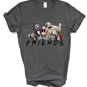 May include: A dark grey t-shirt featuring a graphic print of characters from the film "The Nightmare Before Christmas" and the word "FRIENDS" in a colourful font.