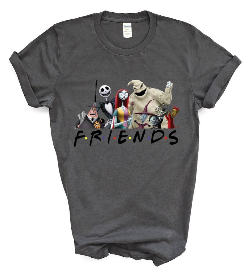 May include: A dark grey t-shirt featuring a graphic print of characters from the film "The Nightmare Before Christmas" and the word "FRIENDS" in a colourful font.