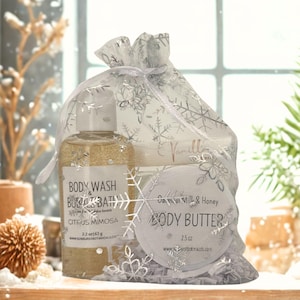 May include: A gift set in a sheer white bag with silver snowflake designs. The set includes a bottle of Citrus Mimosa body wash and a jar of Oatmeal Milk & Honey body butter. The body wash is 2.2 oz and the body butter is 2.5 oz.