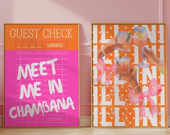 May include: Two framed prints with a pink and orange color scheme. The left print has a pink background with white text that says "GUEST CHECK" and "MEET ME IN CHAMBANA". The right print has an orange background with white text that says "ILL INI" repeated multiple times. The print also features a graphic of three hands holding glasses of cocktails.