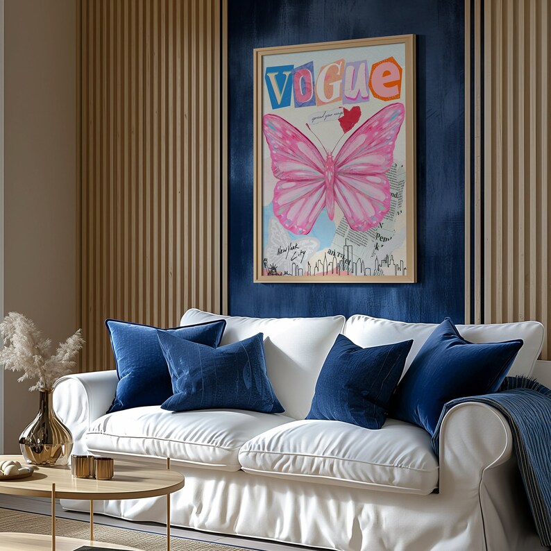 May include: A white sofa with blue velvet cushions in front of a blue wall with a framed print of a pink butterfly and the word "Vogue" in colourful letters.