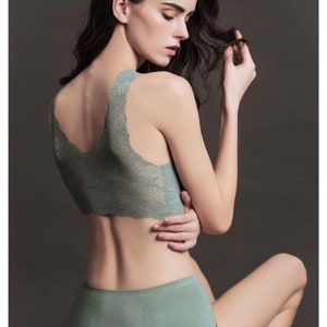 May include: A green lace bralette and matching high-waisted underwear. The underwear has a smooth, seamless finish.