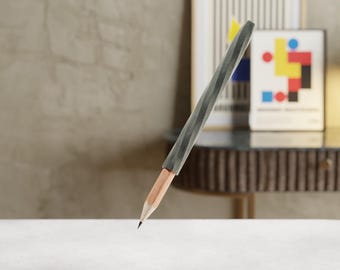 May include: A graphite gray pencil with a unique, textured design. The pencil's wooden core is visible at the tip. The pencil is a writing tool, perfect for drawing or sketching.