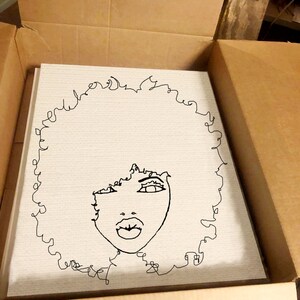 May include: A black and white line drawing of a woman with an afro hairstyle. The drawing is on a white canvas.