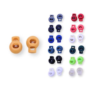 Könnte beinhalten: Sortiment an Kordelstoppern in verschiedenen Farben, darunter Orange, Blau, Rot, Grün, Weiß und Schwarz. Diese kleinen Kunststoff-Toggles dienen zur Anpassung von Kordeln und Kordelzügen. Das Bild zeigt eine Vielzahl von Kordelstoppern.