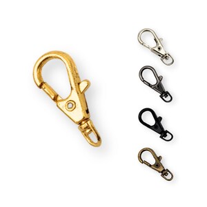 May include: Four metal key chain clips in different finishes: gold, silver, black, and antique brass. The clips are all the same size and shape, with a spring-loaded gate.